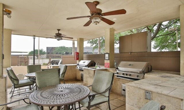 exterior space with area for grilling, an outdoor kitchen, and ceiling fan