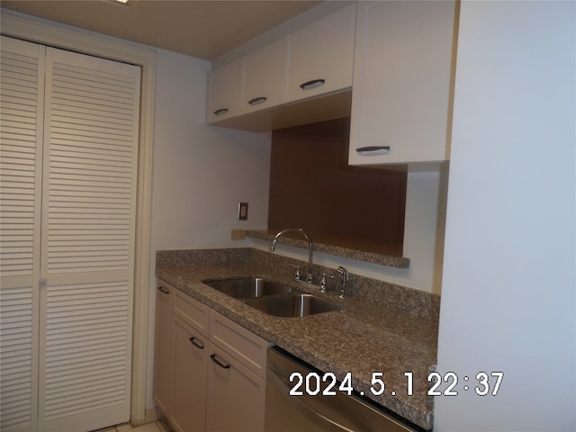 kitchen featuring white cabinetry, sink, and tile flooring