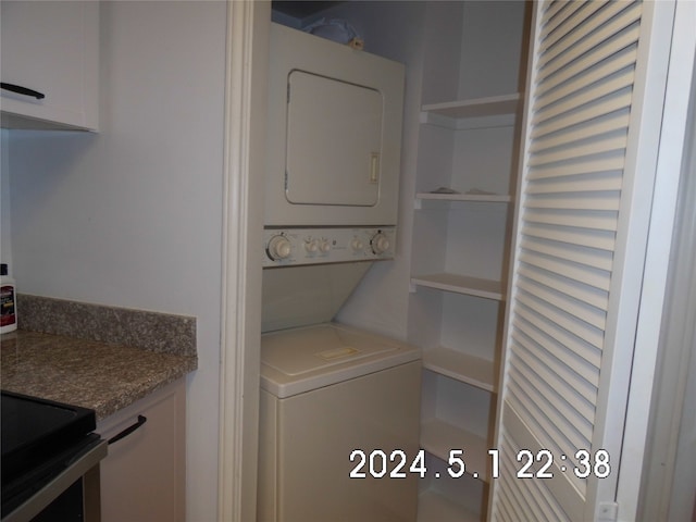 washroom with stacked washer and dryer