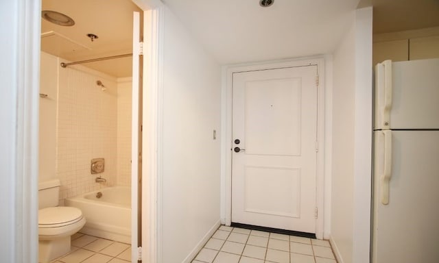 bathroom with tile flooring, shower / bath combination, and toilet