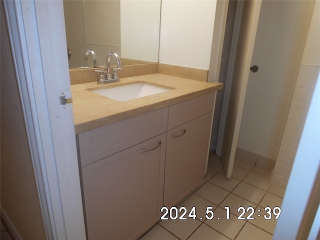 bathroom featuring vanity and tile floors