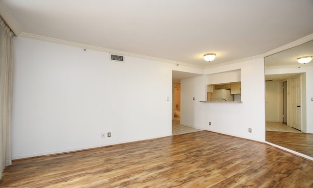 tiled empty room featuring ornamental molding