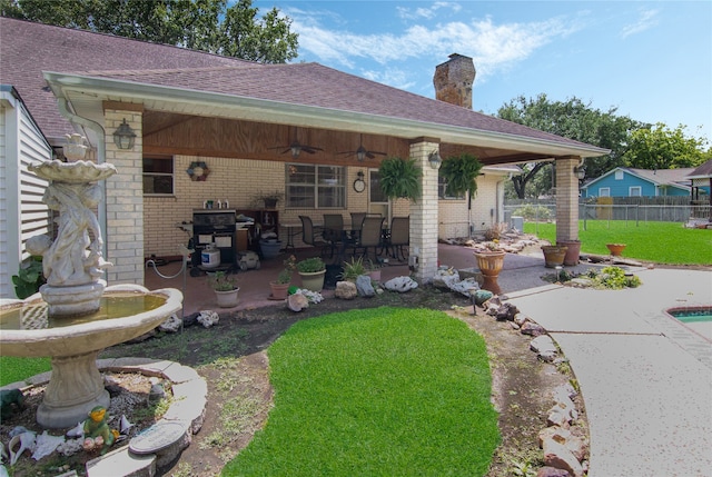 back of property with a pool, ceiling fan, and a patio area