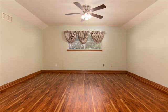 spare room featuring ceiling fan, vaulted ceiling, and dark hardwood / wood-style flooring