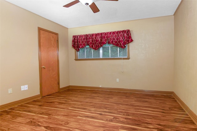 empty room featuring ceiling fan and hardwood / wood-style flooring