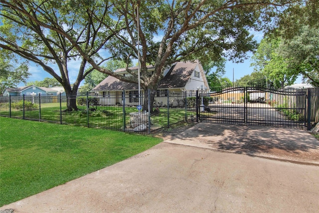 view of gate with a yard