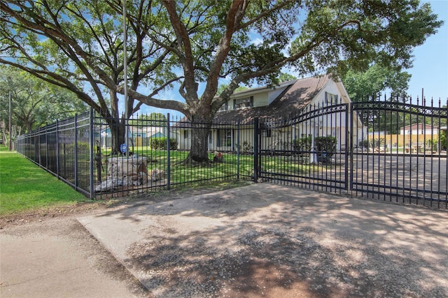 view of gate featuring a lawn