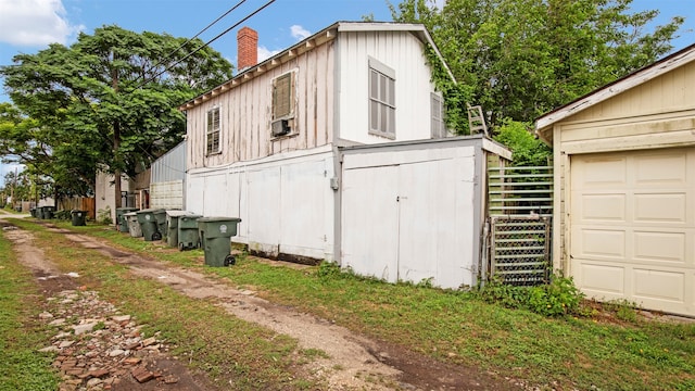 view of side of home featuring a garage