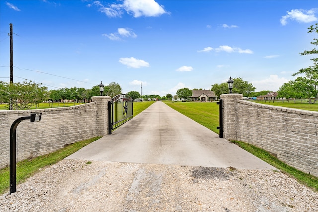 view of gate featuring a lawn