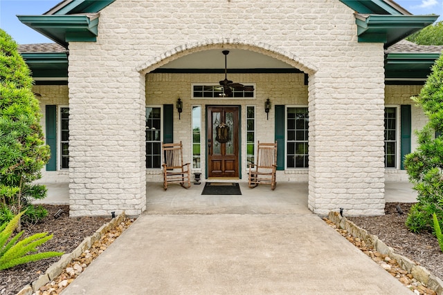 doorway to property with ceiling fan and covered porch