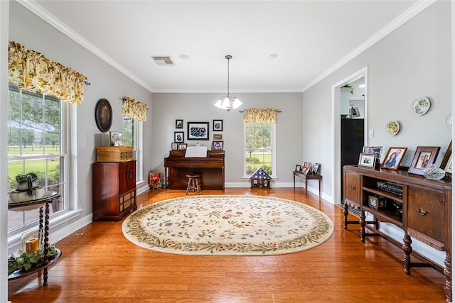 dining area featuring an inviting chandelier, hardwood / wood-style flooring, and ornamental molding