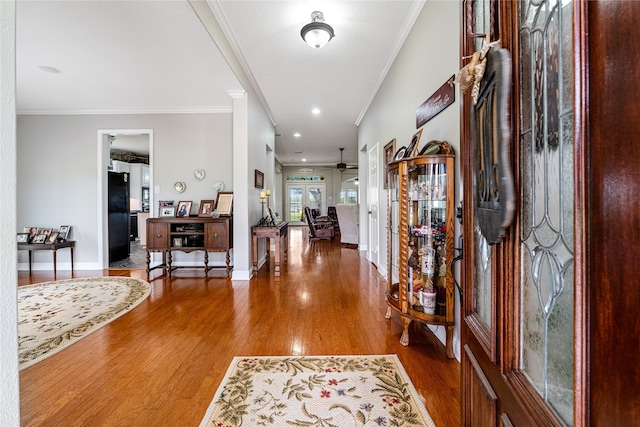 entrance foyer with ornamental molding, hardwood / wood-style floors, and ceiling fan