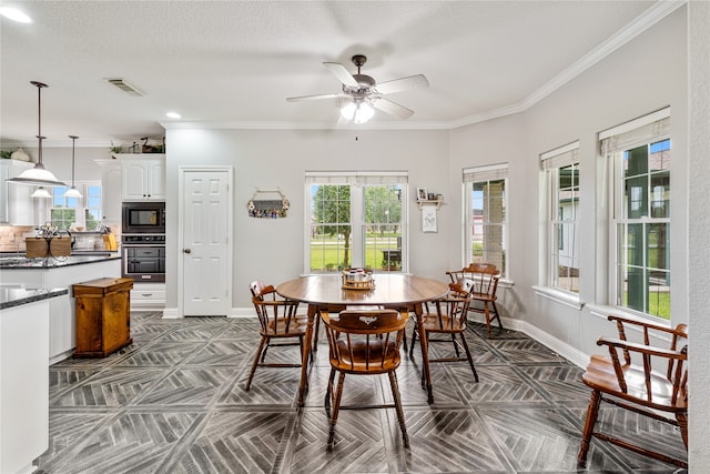 dining area with ceiling fan, ornamental molding, dark parquet floors, and a textured ceiling