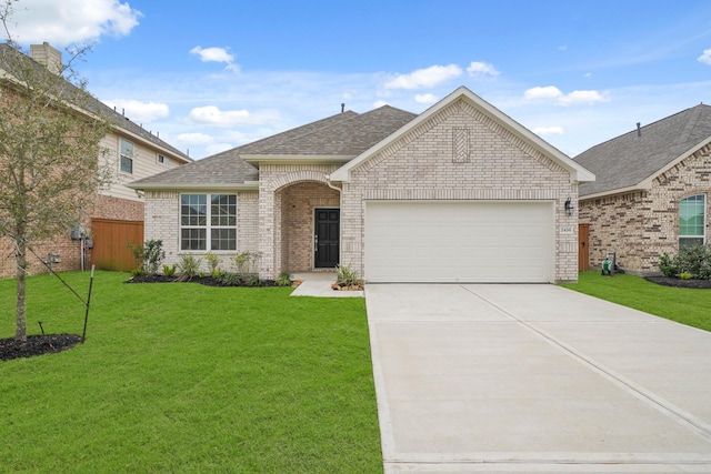 view of front of home featuring a garage and a front lawn