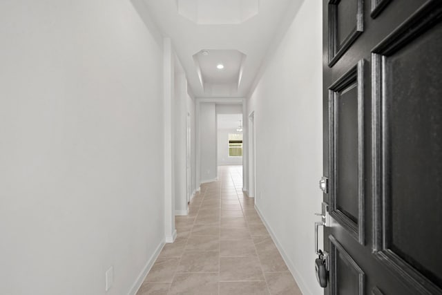 hall with light tile patterned floors