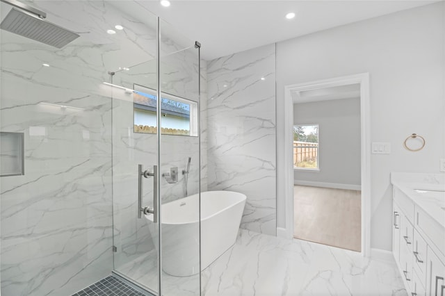 bathroom with tile walls, vanity, tile floors, and separate shower and tub