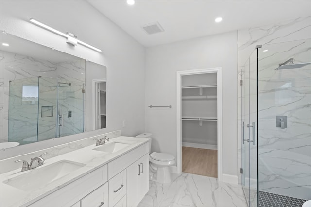 bathroom with a shower with door, tile floors, vanity with extensive cabinet space, and double sink