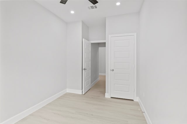 spare room with ceiling fan and light wood-type flooring