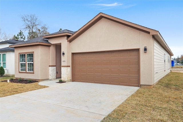 view of front of house featuring a garage and a front lawn