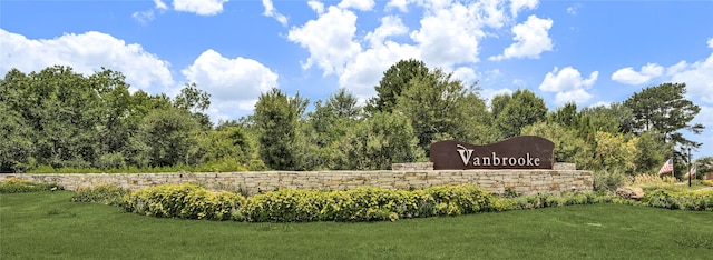 community / neighborhood sign with a lawn