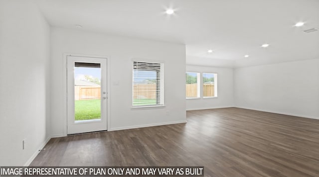 spare room with dark hardwood / wood-style flooring and a healthy amount of sunlight