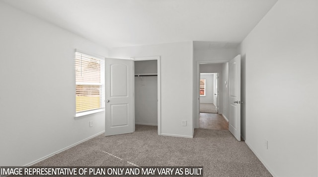 unfurnished bedroom with light colored carpet and a closet