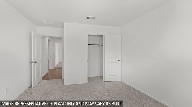 unfurnished bedroom with a closet and light colored carpet