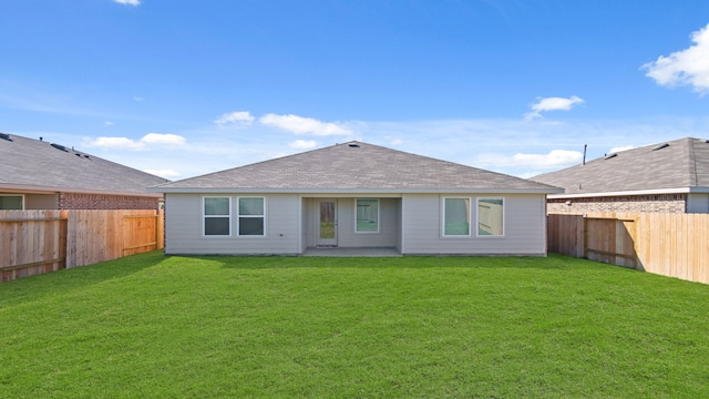 back of house featuring a yard and a patio