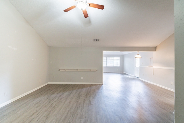 empty room with ceiling fan and hardwood / wood-style flooring