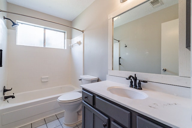 full bathroom with vanity with extensive cabinet space, toilet, tiled shower / bath, a textured ceiling, and tile floors