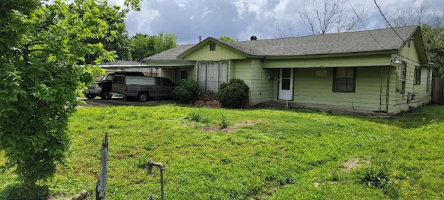 rear view of house featuring a yard