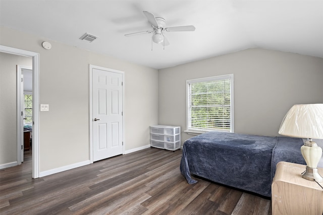 bedroom with vaulted ceiling, ceiling fan, and dark wood-type flooring