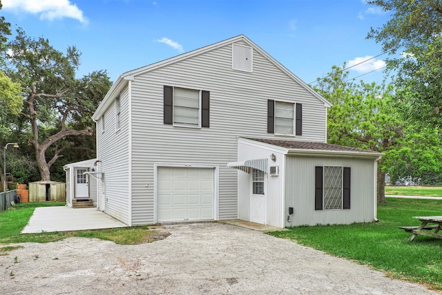 view of property featuring a front yard and a garage