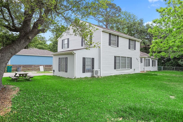 back of house featuring a yard