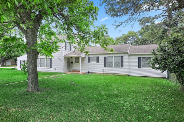 rear view of house with a lawn