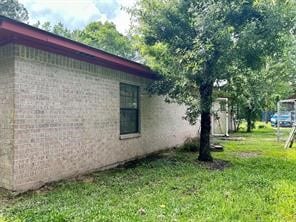 view of side of property with a lawn