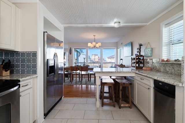 kitchen featuring white cabinets, tasteful backsplash, stainless steel appliances, and light tile flooring