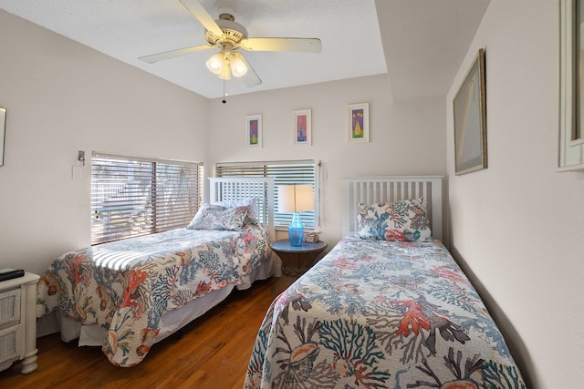 bedroom with dark hardwood / wood-style flooring and ceiling fan