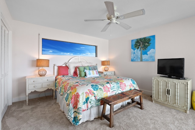 carpeted bedroom with a closet and ceiling fan