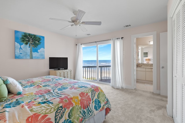 bedroom featuring ceiling fan, a water view, light carpet, connected bathroom, and access to outside