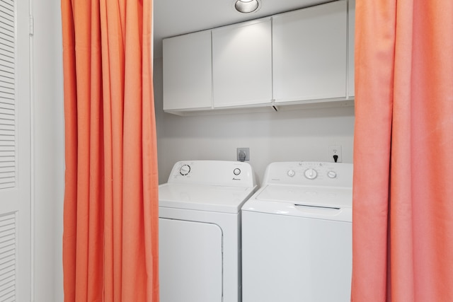 laundry room featuring electric dryer hookup, washer and dryer, and cabinets