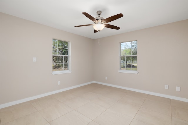 unfurnished room with ceiling fan and light tile patterned flooring