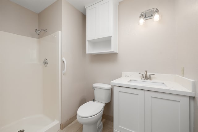 bathroom with vanity, tile patterned floors, toilet, and walk in shower