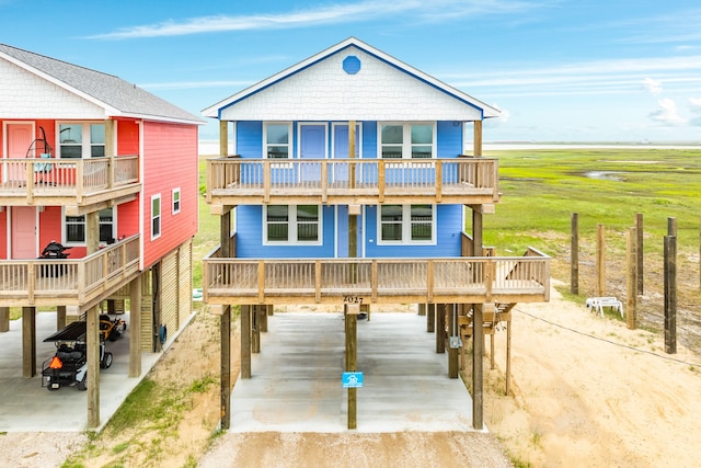 view of front of home with a garage, a carport, and a balcony