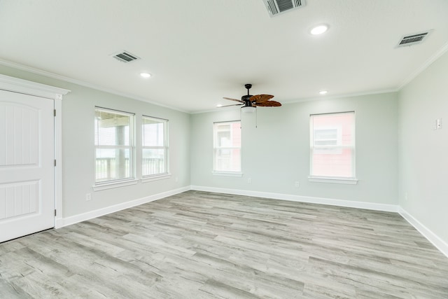 spare room with ornamental molding, ceiling fan, and light wood-type flooring