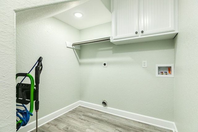 laundry area with cabinets, light wood-type flooring, washer hookup, and electric dryer hookup