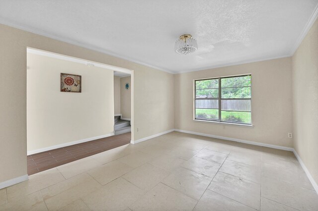 empty room featuring ornamental molding, a textured ceiling, and hardwood / wood-style floors