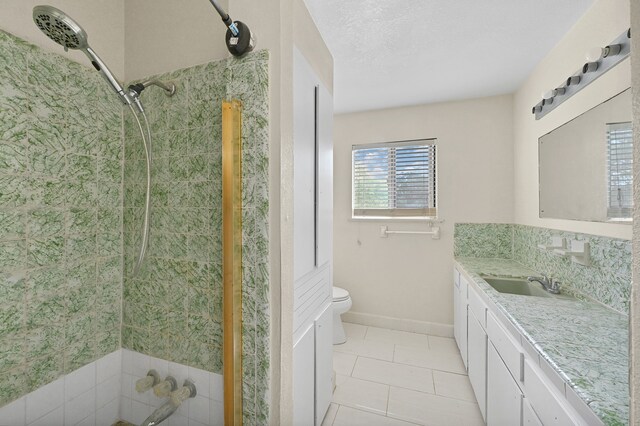 bathroom with toilet, tile floors, and vanity