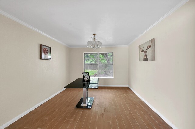 workout room with wood-type flooring, crown molding, and a notable chandelier