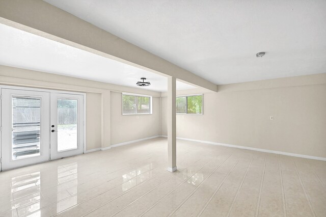 spare room with french doors and light wood-type flooring